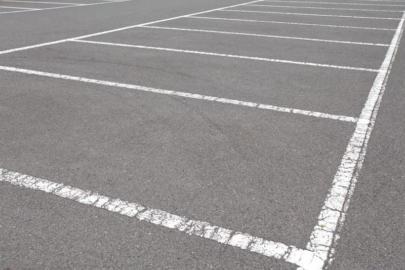 Faded, cracked parking lines before repainting