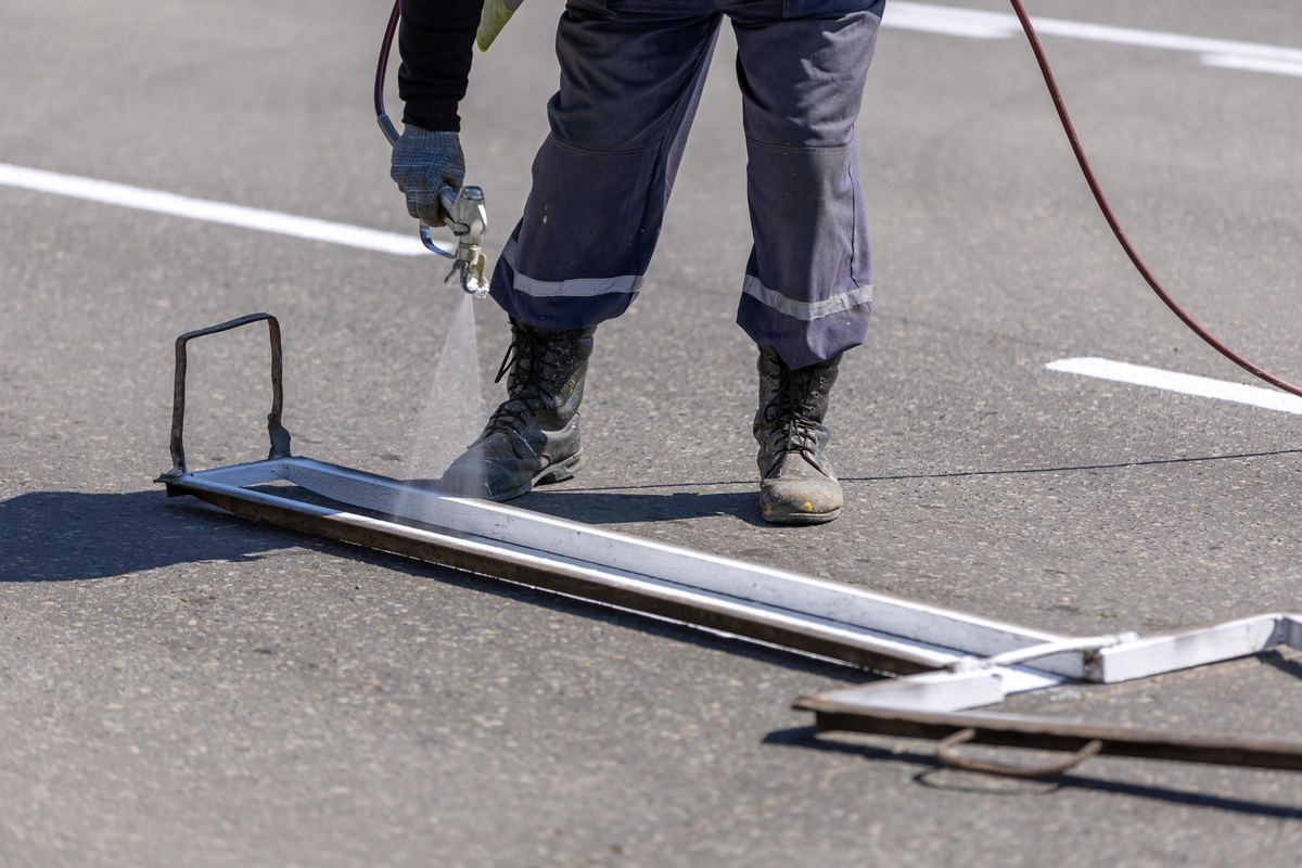 Crew spraying a stencil line